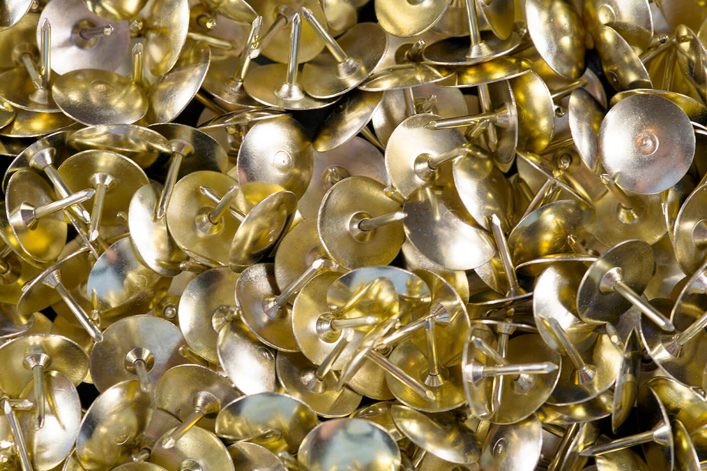 Brass tacks in a pile