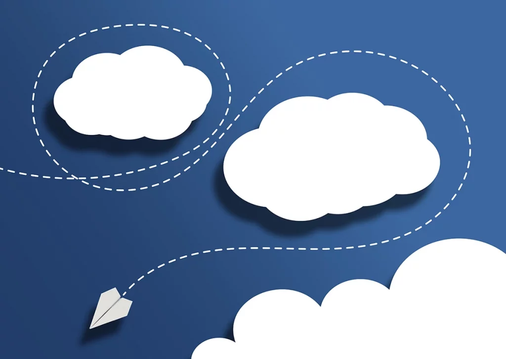 A paper plan flying among paper clouds