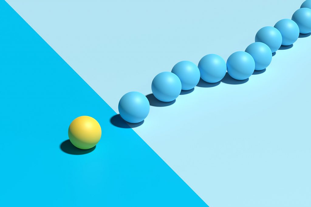A yellow ball being followed by a line of blue balls